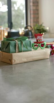 Vertical video: Cam is moving in, focusing and showing gifts, specs, red hat on counter for holiday