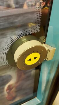 Close up on open door button on public metro line during ride on train in movement. POV from phone in vertical video UGC style during travel on Porto metro in Portugal vacation commuting to city