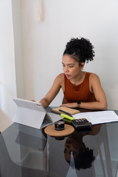 Woman working remotely from home office desk