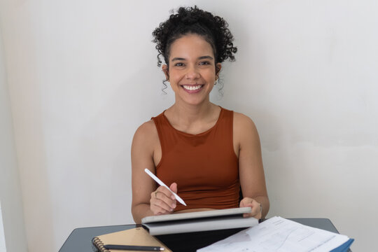 Woman smiling working from home using tablet