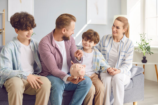 Parents and children together putting coin into a piggy bank at home. Save money as a family, teaching valuable financial lessons and fostering a sense of togetherness and responsibility.