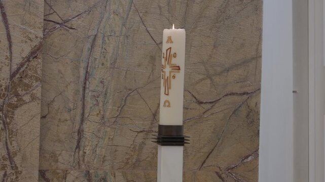 Burning Easter Candle Marked With A Cross Alpha Omega And The Year In A Church