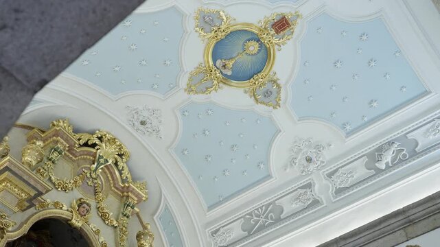 Church ceiling with pale blue stucco panels gilded medallion and painted monstrance