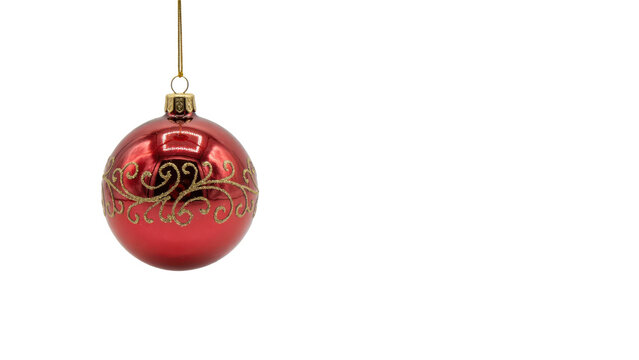 Shiny red christmas ornament bauble with gold glitter swirl pattern hanging from a thin gold string isolated on a transparent background