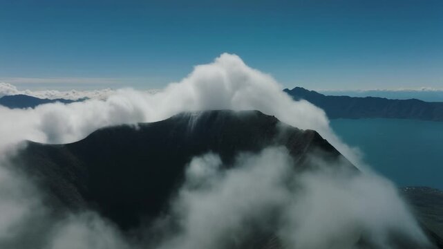 Clouds rolling over guatemala lake atitlan volcano peaks
