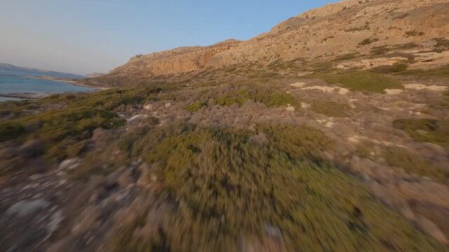 Aerial fpv drone view over dry coastal landscape near Balos beach in Crete Greece.