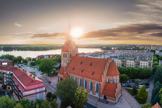 Aerial sunset view of the Sacred Heart Church and lake in Elk Poland