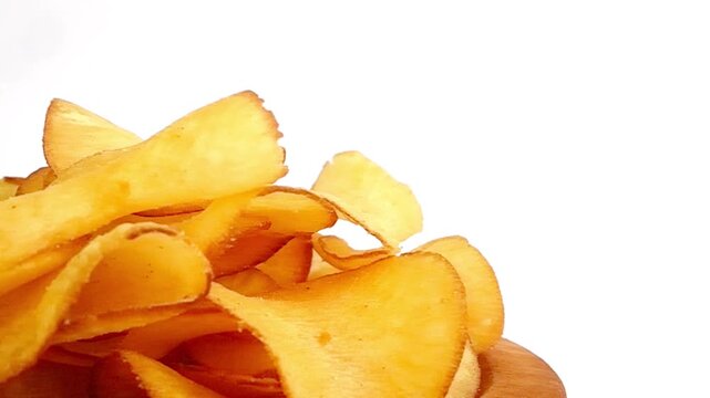 cassava chips served in a wooden bowl with a white background