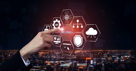 Hand Interacting with No Code Technology Icons Against Urban Night Cityscape Background...