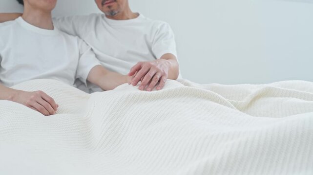 Two men snuggling in bed. Homosexuality, LGBT, romance, lovers, partners, couple, gay, same-sex marriage, gender identity.