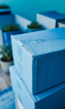 Stack of blue cardboard boxes on a wooden surface