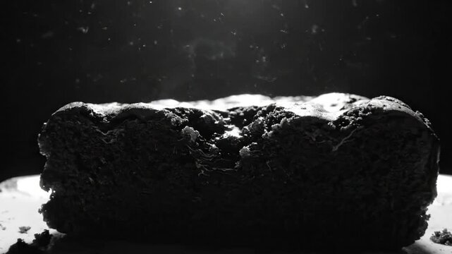 Black and White Close-Up Shot of a Steaming Burnt Loaf of Bread on a White Plate, Dramatic Lighting