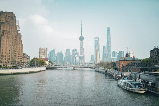Arch bridge spans Suzhou Creek beneath the Pudong skyline, Zhapu Bridge, Shanghai