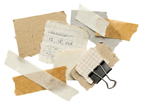 Pile of Torn Paper Scraps and Notes with Binder Clip.