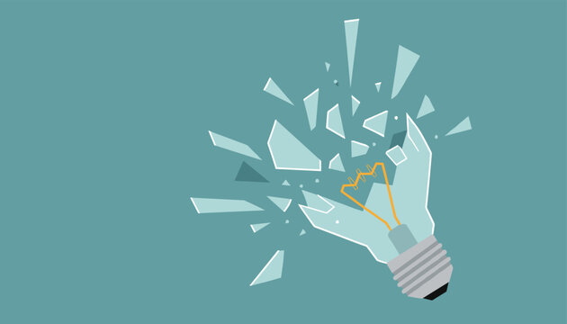 Light bulb shattering into multiple glass shards as a concept of a broken idea or sudden creative burst.