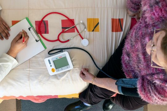 Blood pressure check for older woman in clinic