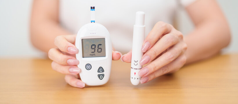 Hand checking Diabetes or Blood glucose self testing by digital blood glucose meter with lancet pen. high blood sugar level, World Diabetes Day, Glycemia, Hypoglycemia, Hyperglycemia and insulin