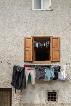 Alleghe, Italy. Traditional household laundry drying outside an old alpine house in the Dolomites