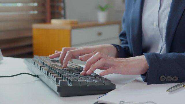 Businesswoman hands typing on a computer keyboard