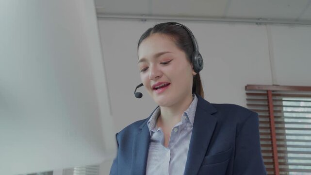 Call center operator assisting client with headset