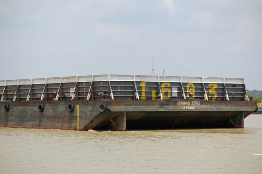 Tugboat towing a pontoon.