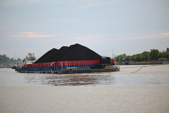 Tugboat towing a pontoon.