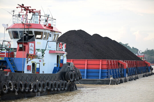 Tugboat towing a pontoon.