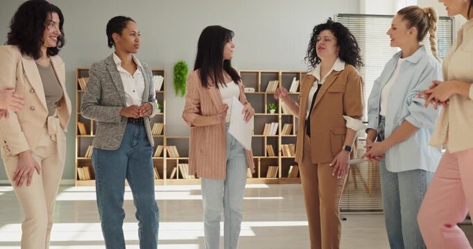 Businesswomen team meeting discussion in modern office. Colleagues share ideas, plan strategy for presentation, ensure clear communication. Teamwork, collaboration and leadership drive results.