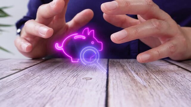 Investment research. Close-up of a person's hands on a table, shielding a virtual piggy bank icon and a magnifying glass