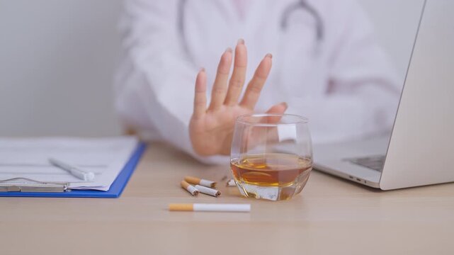 doctor hand making stop sign to refuse whiskey and breaking cigarette, quit smoking and drinking for healthy liver and lung, World No Tobacco and  No Alcohol Day and stop alcohol addiction concept