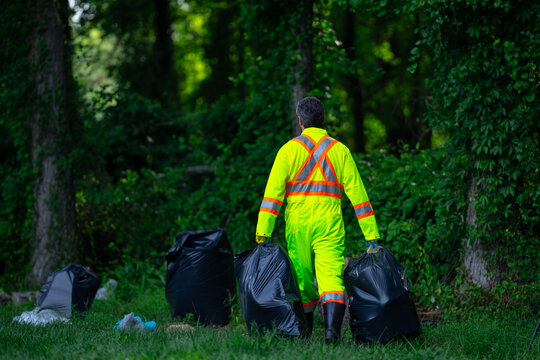 Volunteer man picking plastic trash for cleaning the nature. Clean up garbage outdoor. Ecology concept. Environment Day. Save earth. Recycling bin garbage. Ecology. Environmental care.
