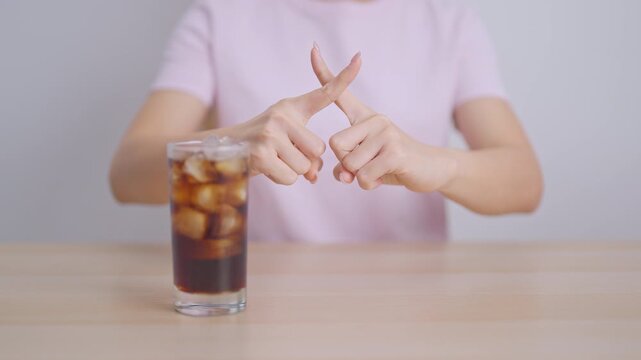 Healthy woman hand stop sign to refuse soft drink and soda, say no to sugar and carbonated beverage, healthy lifestyle, Acid reflux, Heartburn and Gastritis concept