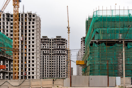 Urban development and construction boom with cranes in Bishkek city. A vivid illustration of the real estate and property development boom in Kyrgyzstan.