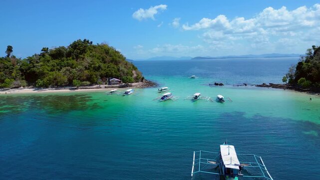 speed ramp hyper motion time lapse alawan tropical islands with lush green vegetation, clear turquoise ocean, and boats near sandy beaches. Unique aerial view fly reverse drone panorama