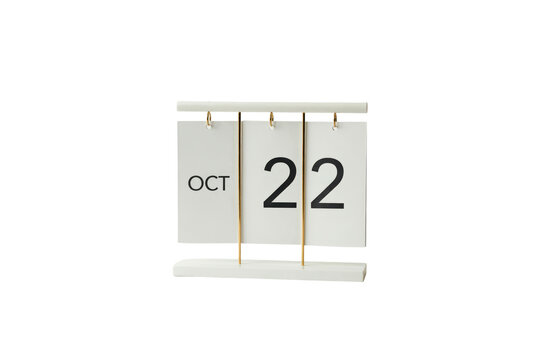 Desktop flip calendar showing october twenty second with white cards and gold metal rings isolated on a transparent background