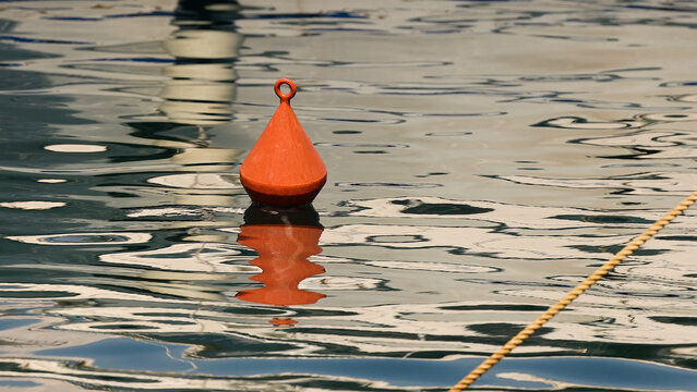 Red Conical Buoy Floating on Calm Water Surface in Monte Carlo