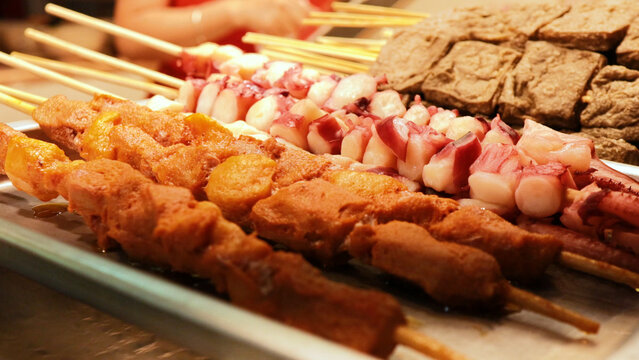 Assorted Street Food Skewers Displayed at a Market in Hong Kong