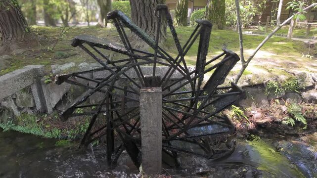Japan - April 10, 2024: Water Wheel in a garden in Japan