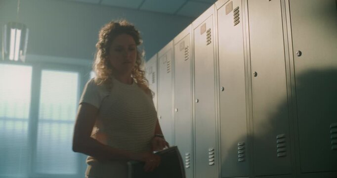 School Teacher Enjoys Rare Moment of Silence in Empty Locker Room, Taking Time to Collect Thoughts Before Welcoming Next Class. Concept of Resilience, Professionalism, and Human Side of Teaching.