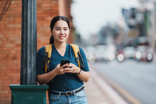 Woman traveling in city using smartphone technology