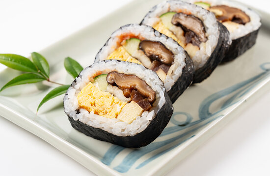 Japanese Futomaki Thick Sushi Rolls on Ceramic Plate Isolated on White Background