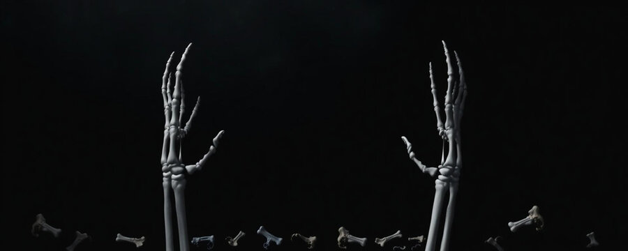 Two skeleton hands reaching upwards from the bottom of the frame against a dark black background with scattered bones at the base