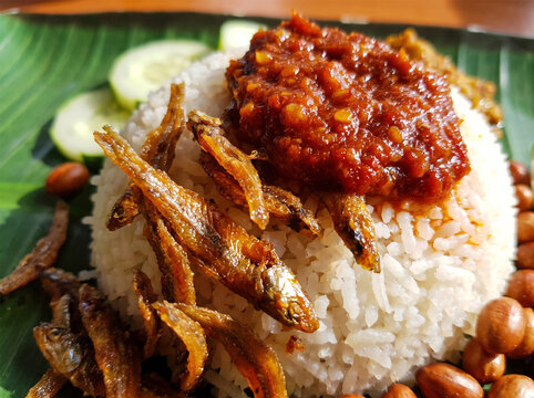 Authentic Malaysian Nasi Lemak coconut rice topped with spicy sambal chili and crispy fried anchovies