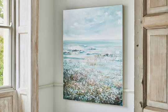 Abstract artwork depicting a calming ocean scene with waves and a textured foreground, bringing coastal vibes into a home decor setting
