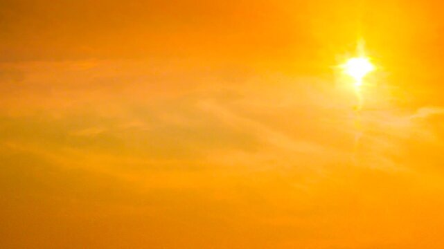 Orange sky background and melting sun. Heat wave concept. Extreme weather. Impact of global warming.