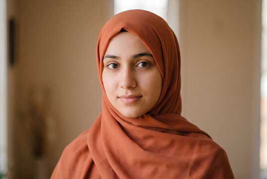 Young woman wearing orange hijab studio portrait