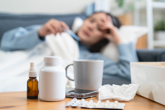 Close-up medicine and tissue on the table and sick people ad background