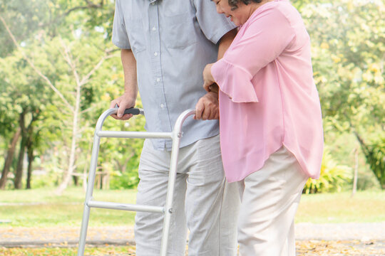 elderly healthy asian couple smile and relax in the park together