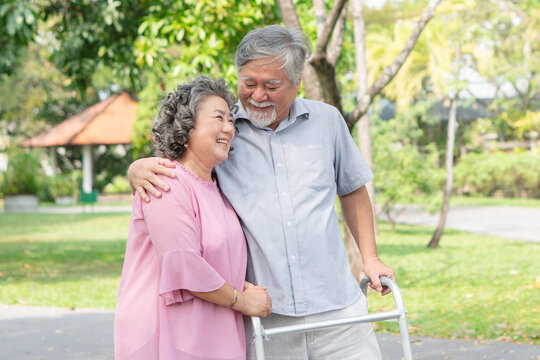 elderly healthy asian couple smile and relax in the park together