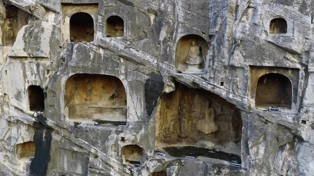 Ancient Buddhist rock‑cut statues, Longmen Grottoes, traces of iconoclasm and cultural looting in Chinese history